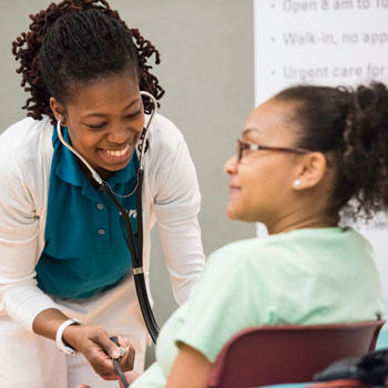 Nursing student tending to patient